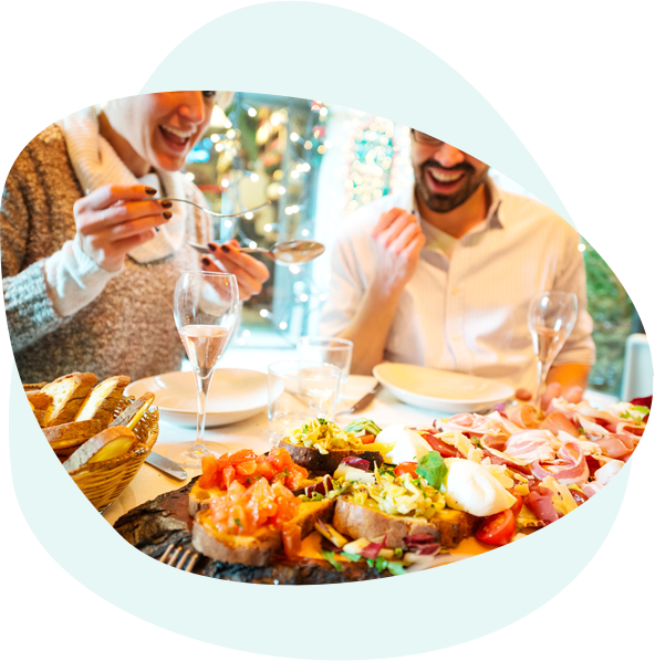 people sitting around a table enjoying Italian food